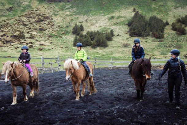 family riding on a beach in iceland